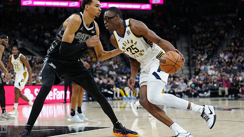 Mar 3, 2024; San Antonio, Texas, USA; Indiana Pacers forward Jalen Smith (25) dribbles against San Antonio Spurs center Victor Wembanyama (1) in the first half at Frost Bank Center. Mandatory Credit: Daniel Dunn-USA TODAY Sports