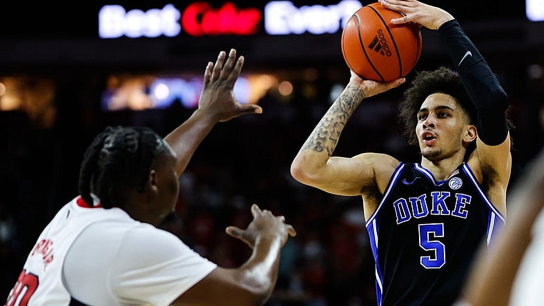 Mar 4, 2024; Raleigh, North Carolina, USA; Duke Blue Devils guard Jeremy Roach (3) shoots the ball past North Carolina State Wolfpack forward DJ Burns Jr. (30) during the first half at PNC Arena. Mandatory Credit: Jaylynn Nash-USA TODAY Sports