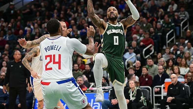 Mar 4, 2024; Milwaukee, Wisconsin, USA;  Milwaukee Bucks guard Damian Lillard (0) takes a shot against Los Angeles Clippers guard Norman Powell (24) in the third quarter at Fiserv Forum. Mandatory Credit: Benny Sieu-USA TODAY Sports