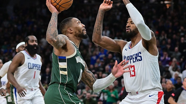 Mar 4, 2024; Milwaukee, Wisconsin, USA; Milwaukee Bucks guard Damian Lillard (0) drives for the basket against Los Angeles Clippers forward Paul George (13) in the fourth quarter at Fiserv Forum. Mandatory Credit: Benny Sieu-USA TODAY Sports