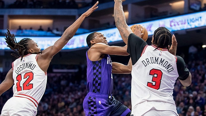 Mar 4, 2024; Sacramento, California, USA; Sacramento Kings guard De'Aaron Fox (5) puts up a shot over Chicago Bulls center Andre Drummond (3) during the second quarter at Golden 1 Center. Mandatory Credit: Ed Szczepanski-USA TODAY Sports