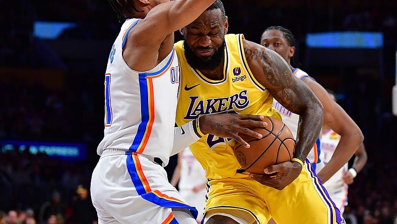 Mar 4, 2024; Los Angeles, California, USA; Los Angeles Lakers forward LeBron James (23) moves to the basket against Oklahoma City Thunder guard Aaron Wiggins (21) during the first half at Crypto.com Arena. Mandatory Credit: Gary A. Vasquez-USA TODAY Sports