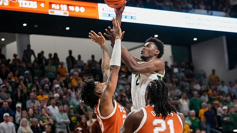Mar 4, 2024; Waco, Texas, USA;  Baylor Bears center Yves Missi (21) scores a basket over Texas Longhorns forward Dillon Mitchell (23) during the second half at Paul and Alejandra Foster Pavilion. Mandatory Credit: Chris Jones-USA TODAY Sports