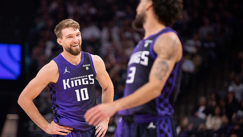 Mar 4, 2024; Sacramento, California, USA; Sacramento Kings forward Domantas Sabonis (10) smiles at guard Chris Duarte (3) during the second quarter at Golden 1 Center. Mandatory Credit: Ed Szczepanski-USA TODAY Sports
