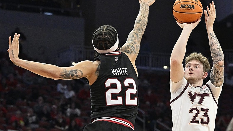 Mar 5, 2024; Louisville, Kentucky, USA; Virginia Tech Hokies guard Tyler Nickel (23) shoots against Louisville Cardinals guard Tre White (22) during the first half at KFC Yum! Center. Mandatory Credit: Jamie Rhodes-USA TODAY Sports