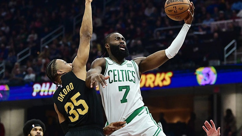 Mar 5, 2024; Cleveland, Ohio, USA;  Boston Celtics guard Jaylen Brown (7) drives to the basket against Cleveland Cavaliers forward Isaac Okoro (35) during the first half at Rocket Mortgage FieldHouse. Mandatory Credit: Ken Blaze-USA TODAY Sports