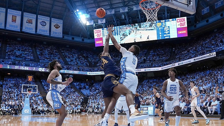 Mar 5, 2024; Chapel Hill, North Carolina, USA; Notre Dame Fighting Irish forward Kebba Njie (14) has his shot blocked by North Carolina Tar Heels forward Armando Bacot (5) during the first half at Dean E. Smith Center. Mandatory Credit: Jim Dedmon-USA TODAY Sports