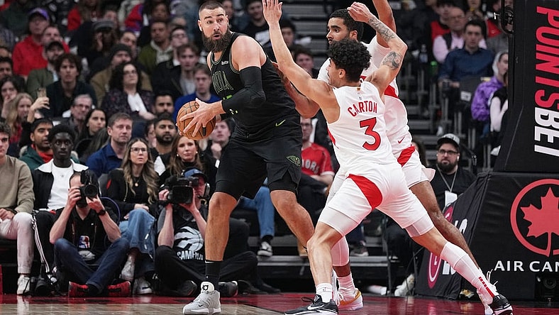 Mar 5, 2024; Toronto, Ontario, CAN; New Orleans Pelicans center Jonas Valanciunas (17) controls the ball as Toronto Raptors guard D.J. Carton (3) tries to defend during the second quarter at Scotiabank Arena. Mandatory Credit: Nick Turchiaro-USA TODAY Sports
