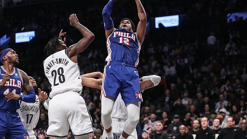 Mar 5, 2024; Brooklyn, New York, USA; Philadelphia 76ers forward Tobias Harris (12) drives past Brooklyn Nets forward Dorian Finney-Smith (28) for a jump shot in the second quarter at Barclays Center. Mandatory Credit: Wendell Cruz-USA TODAY Sports