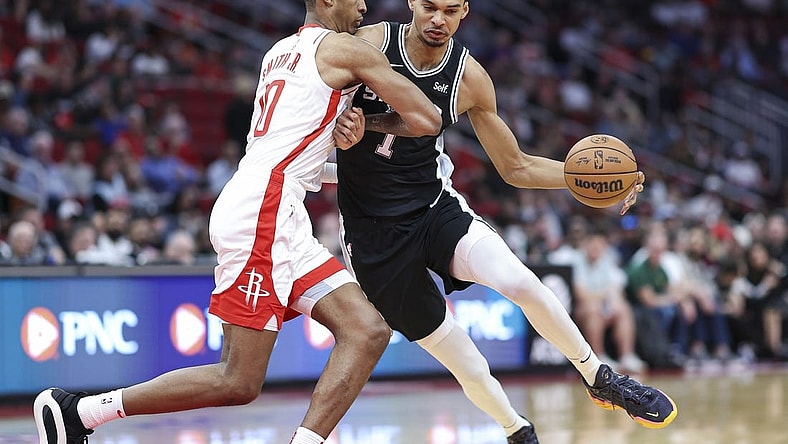 Mar 5, 2024; Houston, Texas, USA; San Antonio Spurs center Victor Wembanyama (1) controls the ball as Houston Rockets forward Jabari Smith Jr. (10) defends during the first quarter at Toyota Center. Mandatory Credit: Troy Taormina-USA TODAY Sports