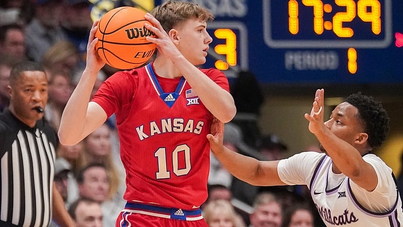 Mar 5, 2024; Lawrence, Kansas, USA; Kansas Jayhawks guard Johnny Furphy (10) looks to pass as Kansas State Wildcats guard Tylor Perry (2) defends during the first half at Allen Fieldhouse. Mandatory Credit: Denny Medley-USA TODAY Sports