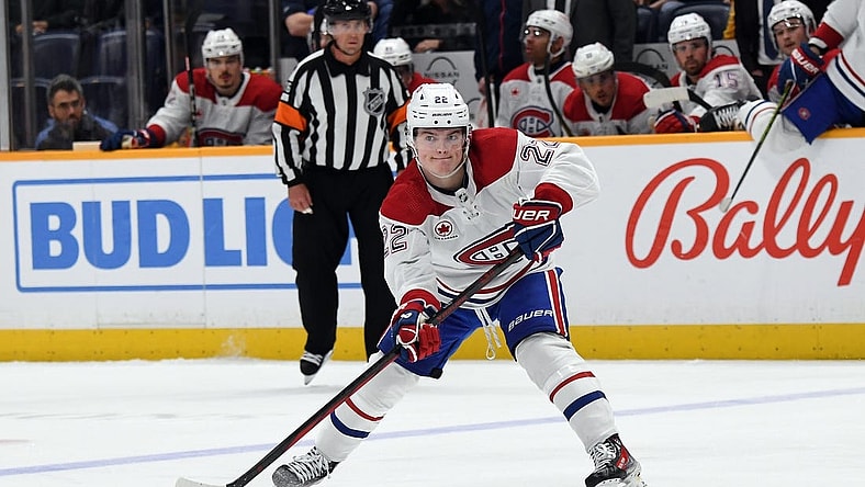 Mar 5, 2024; Nashville, Tennessee, USA; Montreal Canadiens right wing Cole Caufield (22) passes the puck during the second period against the Nashville Predators at Bridgestone Arena. Mandatory Credit: Christopher Hanewinckel-USA TODAY Sports