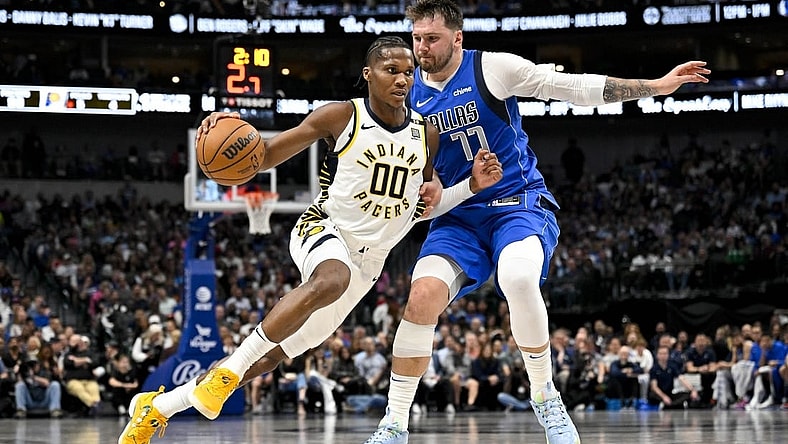 Mar 5, 2024; Dallas, Texas, USA; Indiana Pacers guard Bennedict Mathurin (00) brings the ball up court past Dallas Mavericks guard Luka Doncic (77) during the second half at the American Airlines Center. Mandatory Credit: Jerome Miron-USA TODAY Sports