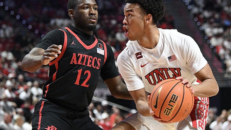 Mar 5, 2024; Las Vegas, Nevada, USA; San Diego State Aztecs guard Darrion Trammell (12) defends against UNLV Rebels guard Dedan Thomas Jr. (11) in the first half at Thomas & Mack Center. Mandatory Credit: Candice Ward-USA TODAY Sports
