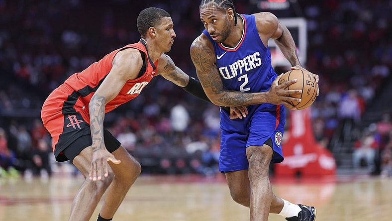 Mar 6, 2024; Houston, Texas, USA; Los Angeles Clippers forward Kawhi Leonard (2) controls the ball as Houston Rockets forward Jabari Smith Jr. (10) defends during the first quarter at Toyota Center. Mandatory Credit: Troy Taormina-USA TODAY Sports
