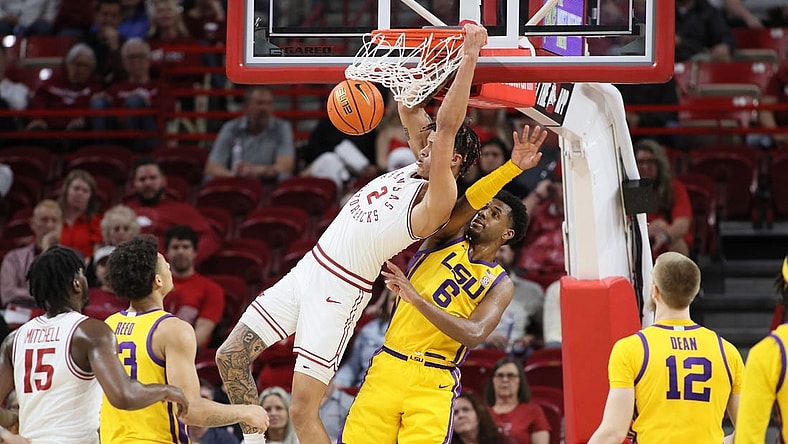 Mar 6, 2024; Fayetteville, Arkansas, USA; Arkansas Razorbacks forward Trevon Brazile (2) dunks the ball in the first half as LSU Tigers guard Jordan Wright (6) defends at Bud Walton Arena. Mandatory Credit: Nelson Chenault-USA TODAY Sports
