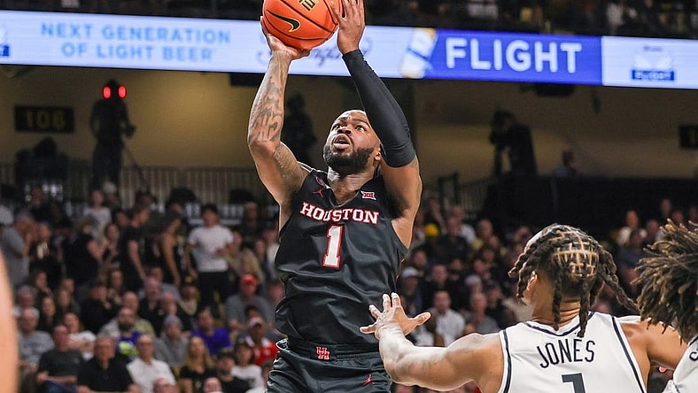 Mar 6, 2024; Orlando, Florida, USA; Houston Cougars guard Jamal Shead (1) goes to the basket in front of UCF Knights guard Antwann Jones (1) during the first half at Addition Financial Arena. Mandatory Credit: Mike Watters-USA TODAY Sports