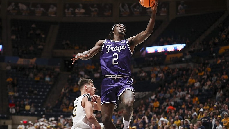 Mar 6, 2024; Morgantown, West Virginia, USA; TCU Horned Frogs forward Emanuel Miller (2) shoots in the lane during the first half against the West Virginia Mountaineers at WVU Coliseum. Mandatory Credit: Ben Queen-USA TODAY Sports