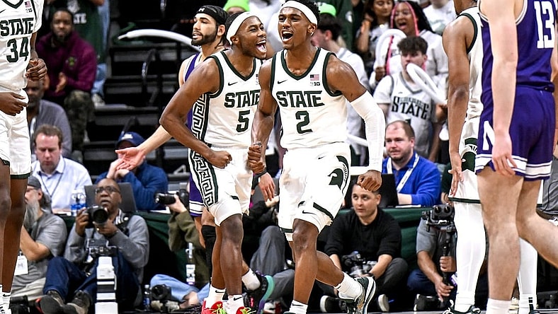 Michigan State's Tyson Walker, right, and Tre Holloman celebrate a Northwestern turnover during the second half on Wednesday, March 6, 2024, at the Breslin Center in East Lansing.