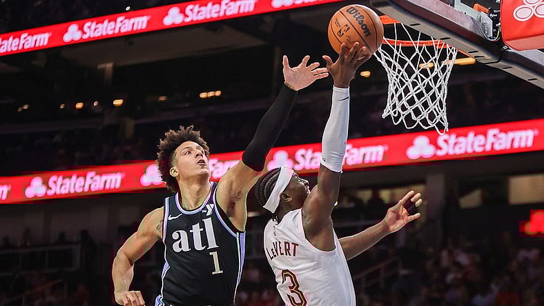 Mar 6, 2024; Atlanta, Georgia, USA; Cleveland Cavaliers guard Caris LeVert (3) shoots past Atlanta Hawks forward Jalen Johnson (1) in the second quarter at State Farm Arena. Mandatory Credit: Brett Davis-USA TODAY Sports