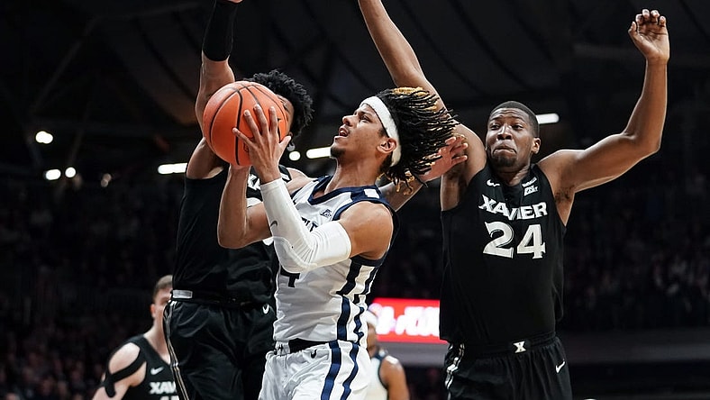 Mar 6, 2024; Indianapolis, Indiana, USA;  Butler Bulldogs guard DJ Davis (4) goes to the basket against Xavier Musketeers guard Dayvion McKnight (20) and Xavier Musketeers forward Abou Ousmane (24) during the first half at Hinkle Fieldhouse. Mandatory Credit: Robert Goddin-USA TODAY Sports