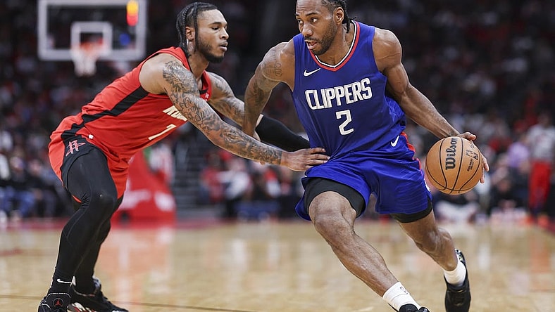 Mar 6, 2024; Houston, Texas, USA; Los Angeles Clippers forward Kawhi Leonard (2) drives with the ball as Houston Rockets forward Cam Whitmore (7) defends during the fourth quarter at Toyota Center. Mandatory Credit: Troy Taormina-USA TODAY Sports