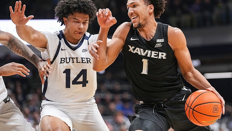 Xavier Musketeers guard Desmond Claude (1) rushes past Butler Bulldogs guard Landon Moore (14) on Wednesday, March 6, 2024, during the game at Hinkle Fieldhouse in Indianapolis. The Butler Bulldogs defeated the Xavier Musketeers, 72-66.
