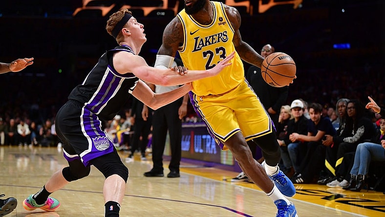 Mar 6, 2024; Los Angeles, California, USA;  Los Angeles Lakers forward LeBron James (23) moves the ball against Sacramento Kings guard Kevin Huerter (9) during the second half at Crypto.com Arena. Mandatory Credit: Gary A. Vasquez-USA TODAY Sports