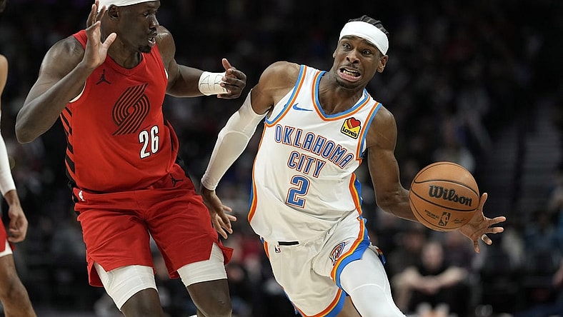 Mar 6, 2024; Portland, Oregon, USA; Oklahoma City Thunder point guard Shai Gilgeous-Alexander (2) is fouled by Portland Trail Blazers center Duop Reath (26) during the second half at Moda Center. Mandatory Credit: Soobum Im-USA TODAY Sports