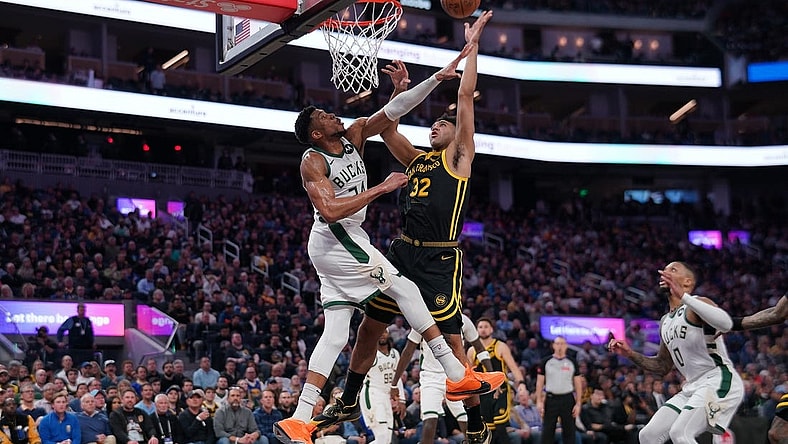 Mar 6, 2024; San Francisco, California, USA; Golden State Warriors forward Trayce Jackson-Davis (32) makes a shot over Milwaukee Bucks forward Giannis Antetokounmpo (34) in the third quarter at the Chase Center. Mandatory Credit: Cary Edmondson-USA TODAY Sports