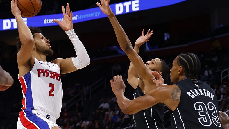 Mar 7, 2024; Detroit, Michigan, USA;  Detroit Pistons guard Cade Cunningham (2) shoots over Brooklyn Nets center Nic Claxton (33) in the first half at Little Caesars Arena. Mandatory Credit: Rick Osentoski-USA TODAY Sports