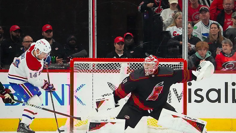 Mar 7, 2024; Raleigh, North Carolina, USA; Montreal Canadiens center Nick Suzuki (14) takes a shot on Carolina Hurricanes goaltender Frederik Andersen (31) during the first period at PNC Arena. Mandatory Credit: James Guillory-USA TODAY Sports