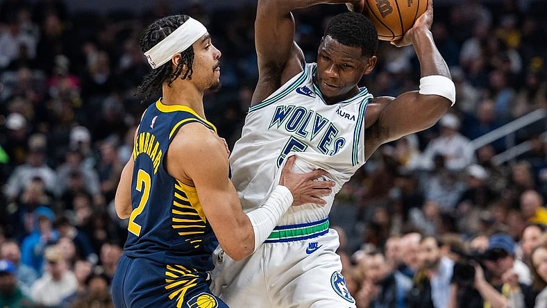 Mar 7, 2024; Indianapolis, Indiana, USA; Minnesota Timberwolves guard Anthony Edwards (5) holds the ball while Indiana Pacers guard Andrew Nembhard (2) defends during the first half at Gainbridge Fieldhouse. Mandatory Credit: Trevor Ruszkowski-USA TODAY Sports