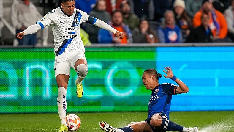 FC Cincinnati forward Yuya Kubo (7) slides under Monterrey midfielder Maximiliano Meza (11) in the first half of the CONCACAF Champions Cup Round of 16 game between the FC Cincinnati and the Monterrey at TQL Stadium in Cincinnati on Thursday, March 7, 2024. Monterrey led 1-0 at halftime.
