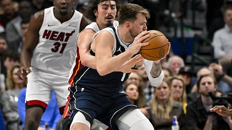 Mar 7, 2024; Dallas, Texas, USA; Miami Heat guard Jaime Jaquez Jr. (11) attempts to knock the ball away from Dallas Mavericks guard Luka Doncic (77) during the first half at the American Airlines Center. Mandatory Credit: Jerome Miron-USA TODAY Sports