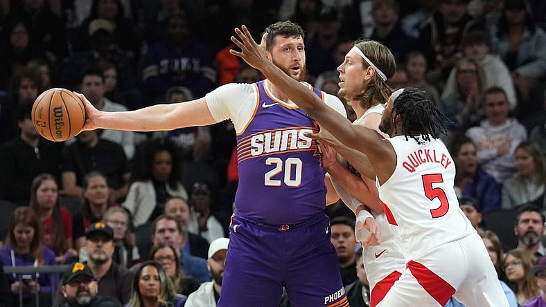 Mar 7, 2024; Phoenix, Arizona, USA; Phoenix Suns center Jusuf Nurkic (20) protects the ball from Toronto Raptors forward Kelly Olynyk (41) and Toronto Raptors guard Immanuel Quickley (5) during the first half at Footprint Center. Mandatory Credit: Joe Camporeale-USA TODAY Sports