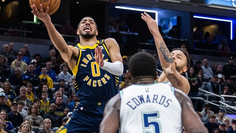 Mar 7, 2024; Indianapolis, Indiana, USA; Indiana Pacers guard Tyrese Haliburton (0) shoots the ball while Minnesota Timberwolves forward Kyle Anderson (1) defends during the second half at Gainbridge Fieldhouse. Mandatory Credit: Trevor Ruszkowski-USA TODAY Sports