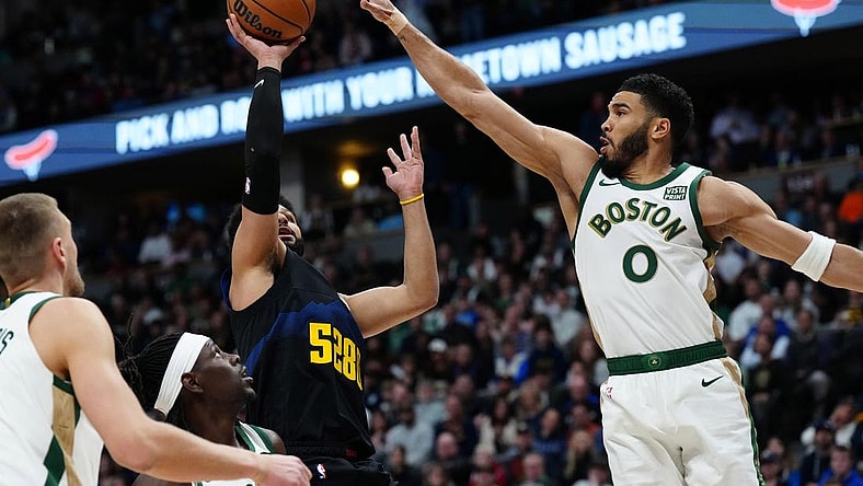 Mar 7, 2024; Denver, Colorado, USA; Denver Nuggets guard Jamal Murray (27) shoots the ball at Boston Celtics forward Jayson Tatum (0) in the first quarter at Ball Arena. Mandatory Credit: Ron Chenoy-USA TODAY Sports