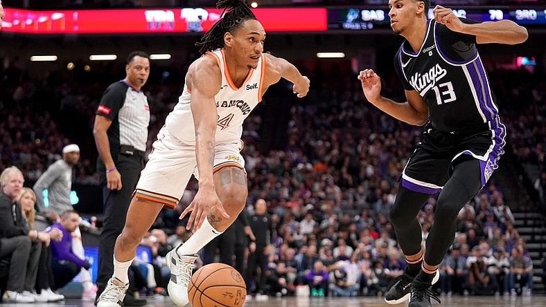 Mar 7, 2024; Sacramento, California, USA; San Antonio Spurs guard Devin Vassell (24) dribbles past Sacramento Kings forward Keegan Murray (13) in the third quarter at the Golden 1 Center. Mandatory Credit: Cary Edmondson-USA TODAY Sports