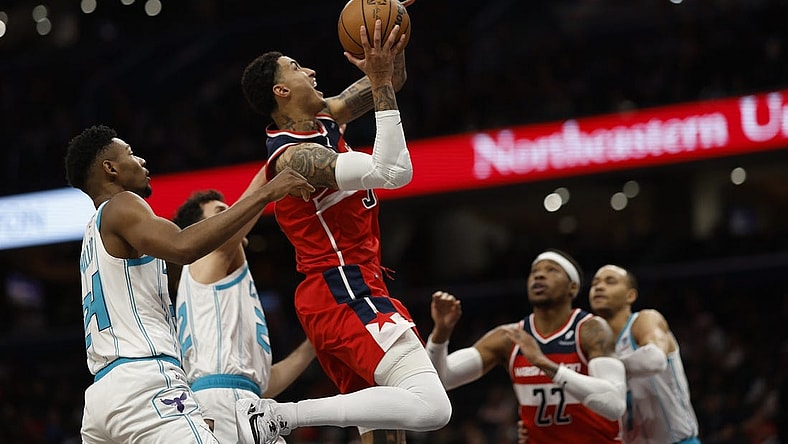 Mar 8, 2024; Washington, District of Columbia, USA;  Washington Wizards forward Kyle Kuzma (33) shoots the ball while being fouled by Charlotte Hornets forward Brandon Miller (24) in the first halfat Capital One Arena. Mandatory Credit: Geoff Burke-USA TODAY Sports