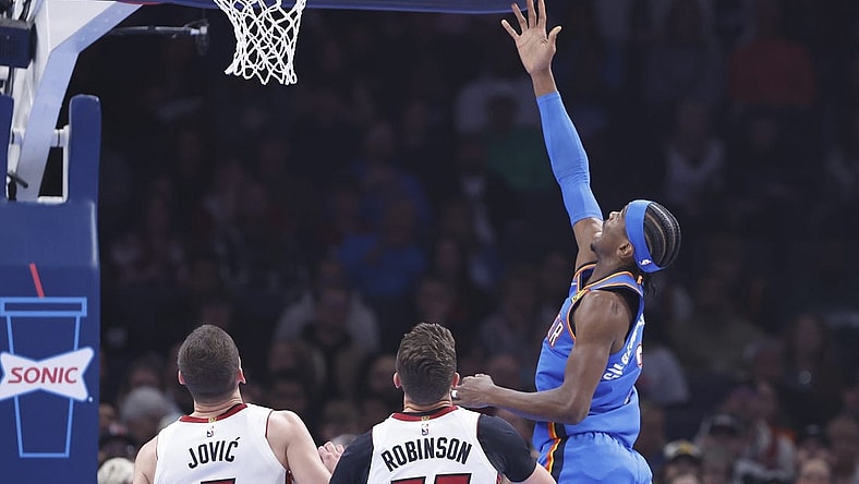 Mar 8, 2024; Oklahoma City, Oklahoma, USA; Oklahoma City Thunder guard Shai Gilgeous-Alexander (2) lays up a shot in front of Miami Heat forward Duncan Robinson (55) during the first quarter at Paycom Center. Mandatory Credit: Alonzo Adams-USA TODAY Sports