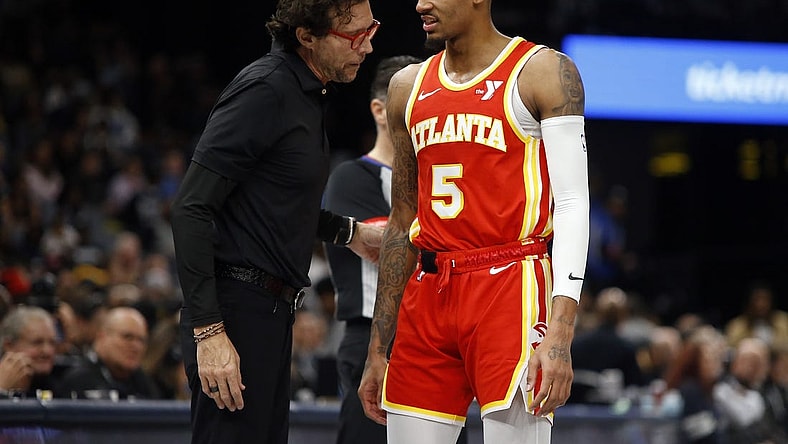 Mar 8, 2024; Memphis, Tennessee, USA; Atlanta Hawks head coach Quin Snyder (left) talks with Atlanta Hawks guard Dejounte Murray (5) during the first half against the Memphis Grizzlies at FedExForum. Mandatory Credit: Petre Thomas-USA TODAY Sports