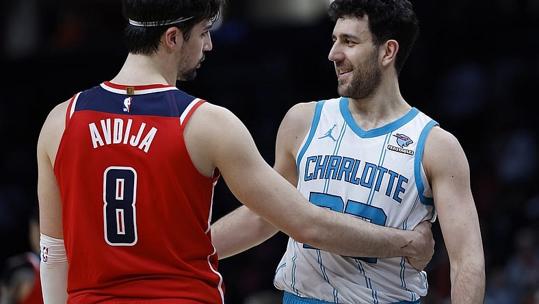 Mar 8, 2024; Washington, District of Columbia, USA; Washington Wizards forward Deni Avdija (8) hugs Charlotte Hornets guard Vasa Micic (22) after their game at Capital One Arena. Mandatory Credit: Geoff Burke-USA TODAY Sports