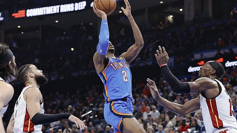 Mar 8, 2024; Oklahoma City, Oklahoma, USA; Oklahoma City Thunder guard Shai Gilgeous-Alexander (2) shoots in front of Miami Heat center Bam Adebayo (13) during the second half at Paycom Center. Mandatory Credit: Alonzo Adams-USA TODAY Sports