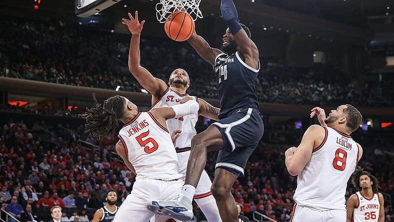 Mar 9, 2024; New York, New York, USA;  Georgetown Hoyas forward Supreme Cook (24) dunks past St. John's Red Storm guard Daniss Jenkins (5) in the first half at Madison Square Garden. Mandatory Credit: Wendell Cruz-USA TODAY Sports
