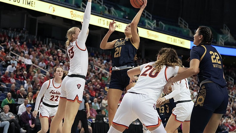 Mar 9, 2024; Greensboro, NC, USA; Notre Dame Fighting Irish forward Maddy Westbeld (21) shoots the ball over Notre Dame Fighting Irish guard Anna DeWolfe (13) during the second half at Greensboro Coliseum. Mandatory Credit: David Yeazell-USA TODAY Sports