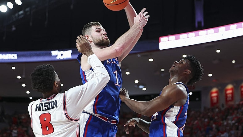 Mar 9, 2024; Houston, Texas, USA; Kansas Jayhawks center Hunter Dickinson (1) attempts to score as Houston Cougars guard Mylik Wilson (8) defends during the first half at Fertitta Center. Mandatory Credit: Troy Taormina-USA TODAY Sports