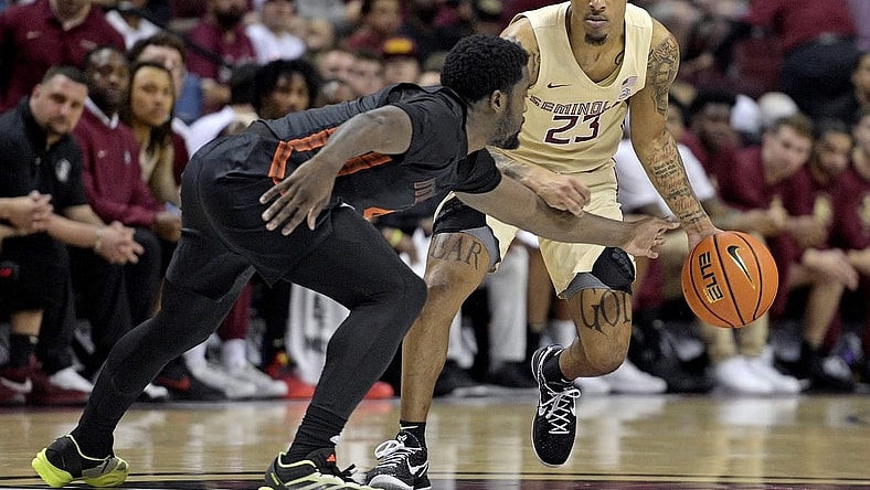 Mar 9, 2024; Tallahassee, Florida, USA; Florida State Seminoles guard Primo Spears (23) controls the ball against Miami Hurricanes guard Bensley Joseph (4) during the first half at Donald L. Tucker Center. Mandatory Credit: Melina Myers-USA TODAY Sports