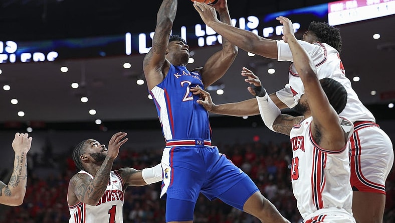 Mar 9, 2024; Houston, Texas, USA; Kansas Jayhawks forward K.J. Adams Jr. (24) attempts to control the ball as Houston Cougars center Cedric Lath (2) defends during the first half at Fertitta Center. Mandatory Credit: Troy Taormina-USA TODAY Sports