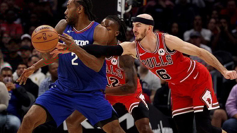 Mar 9, 2024; Los Angeles, California, USA; Chicago Bulls guard Alex Caruso (6) knocks the ball away from LA Clippers forward Kawhi Leonard (2) during the second quarter at Crypto.com Arena. Mandatory Credit: Jason Parkhurst-USA TODAY Sports